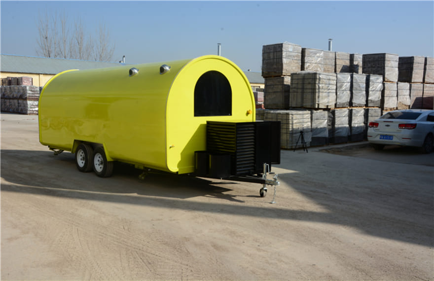 the rear of the yellow pizza concession trailer